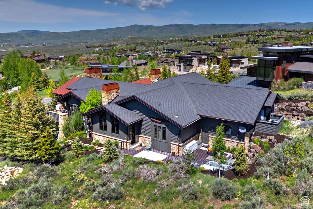 Aerial view of property and surrounding area with mountains