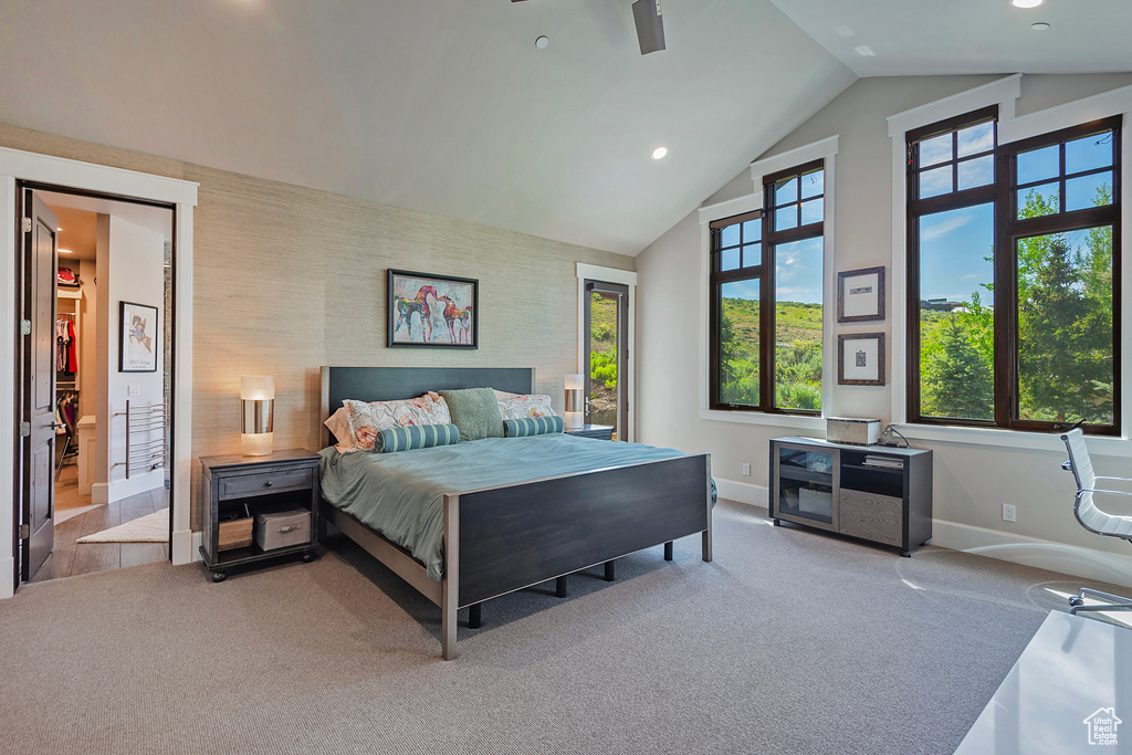 Carpeted bedroom featuring baseboards, lofted ceiling, recessed lighting, and an accent wall