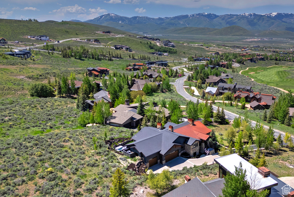 Aerial perspective of suburban area featuring a mountain backdrop