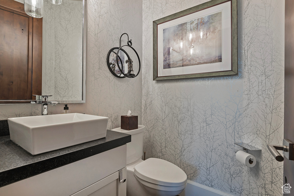 Half bath featuring toilet and vanity