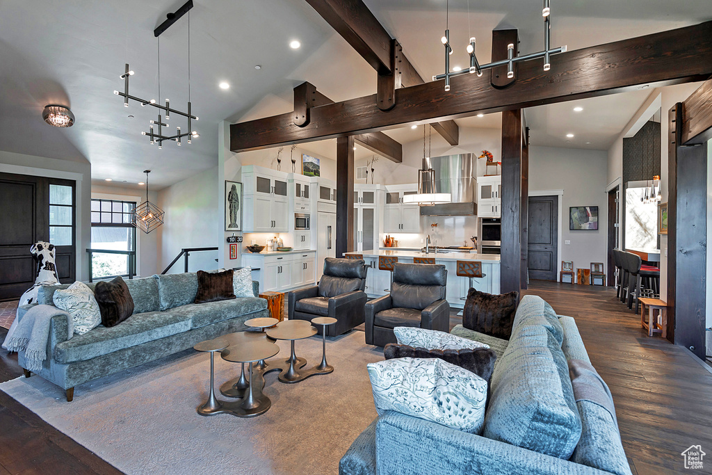 Living area with a chandelier, dark wood-style flooring, beamed ceiling, high vaulted ceiling, and recessed lighting