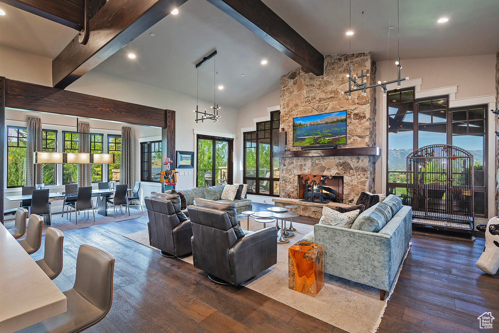 Living area featuring beamed ceiling, wood finished floors, recessed lighting, high vaulted ceiling, and a fireplace
