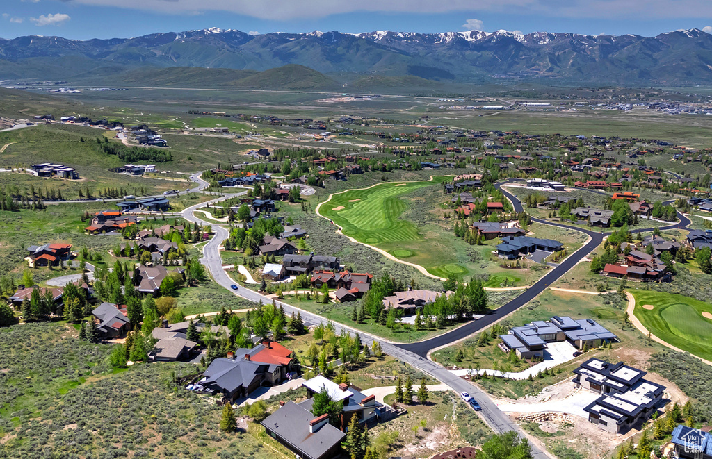 Aerial view of property\\\'s location featuring a mountainous background, a local golf course, and nearby suburban area