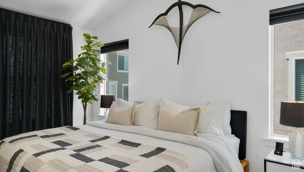 Bedroom featuring lofted ceiling