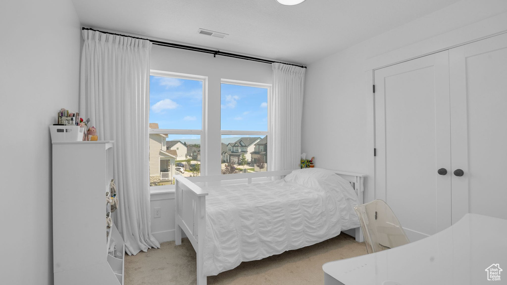 Bedroom featuring light colored carpet