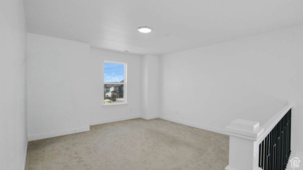 Spare room with carpet and baseboards
