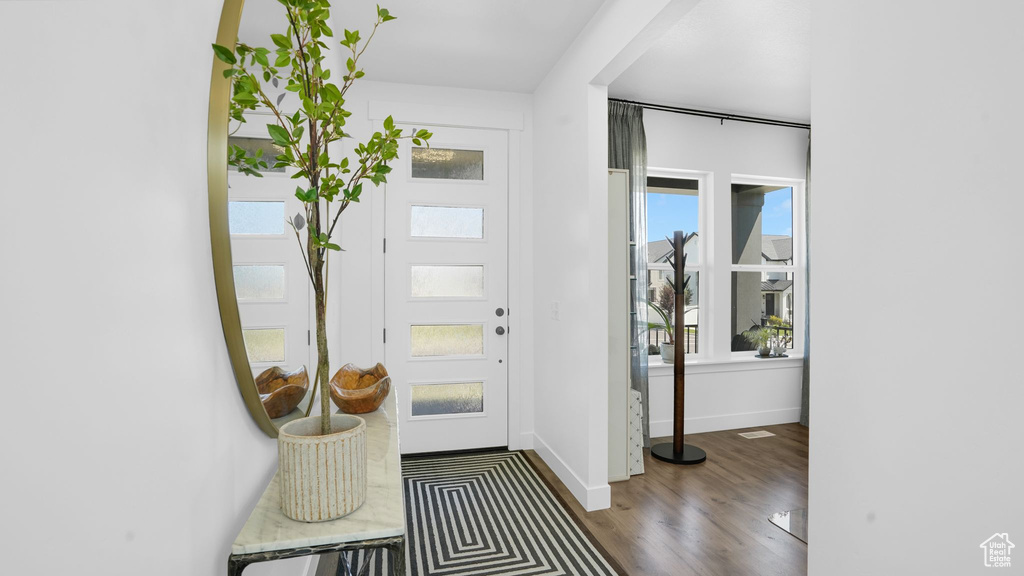 Foyer featuring wood finished floors and baseboards