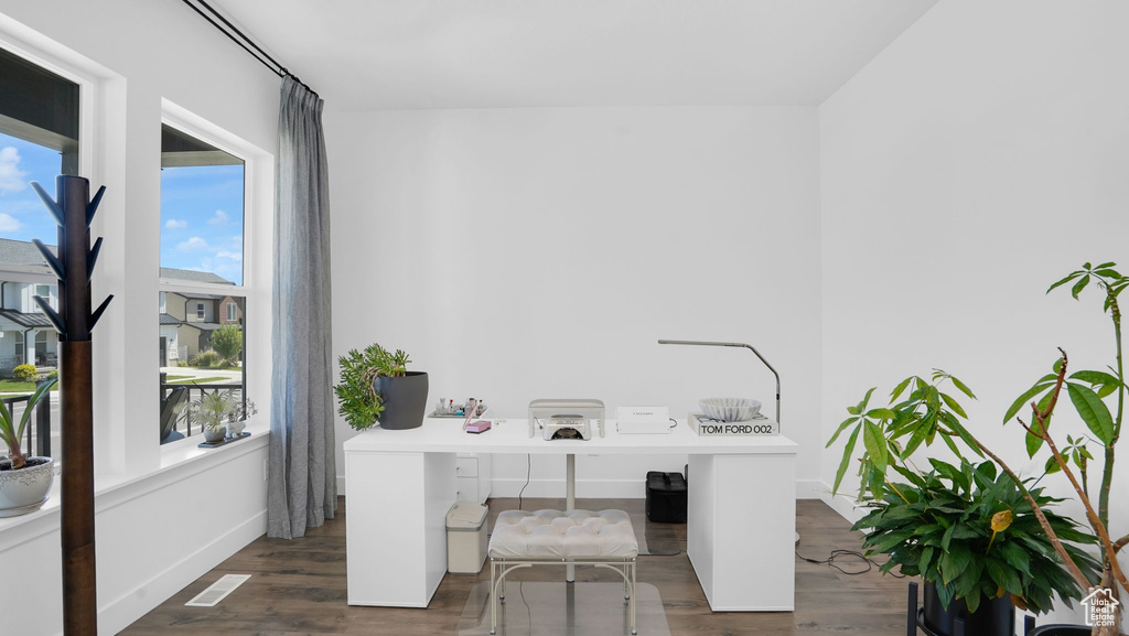 Office with plenty of natural light, wood finished floors, and baseboards
