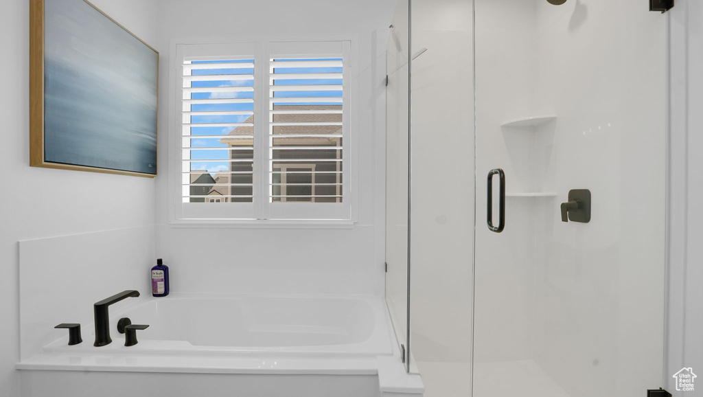 Full bathroom with a stall shower and a bath