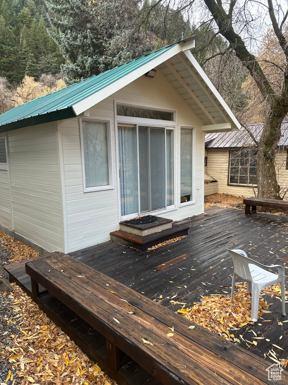 Wooden terrace featuring an outbuilding