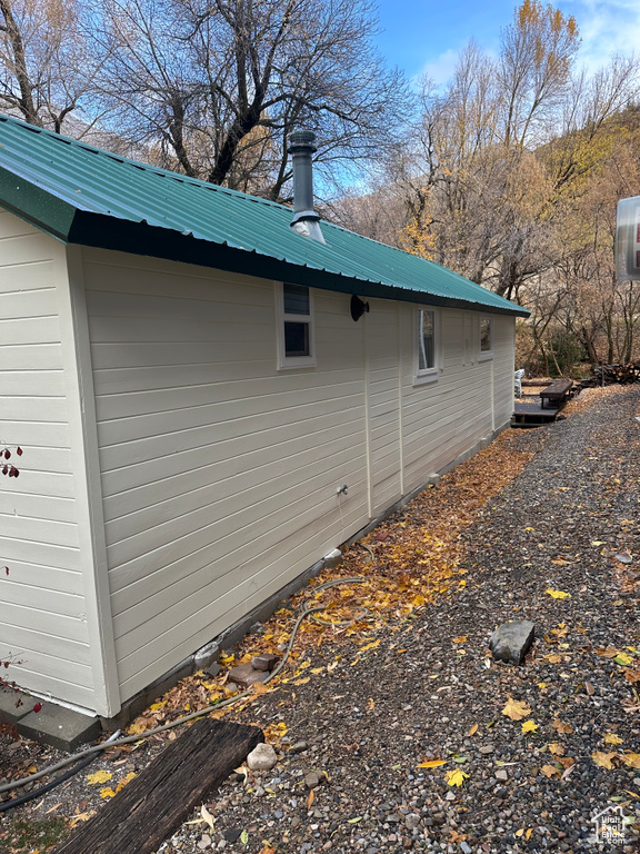 View of side of property featuring metal roof