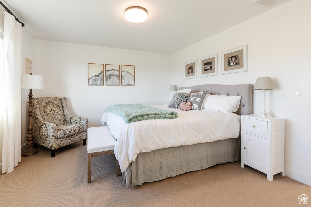 Bedroom with light colored carpet