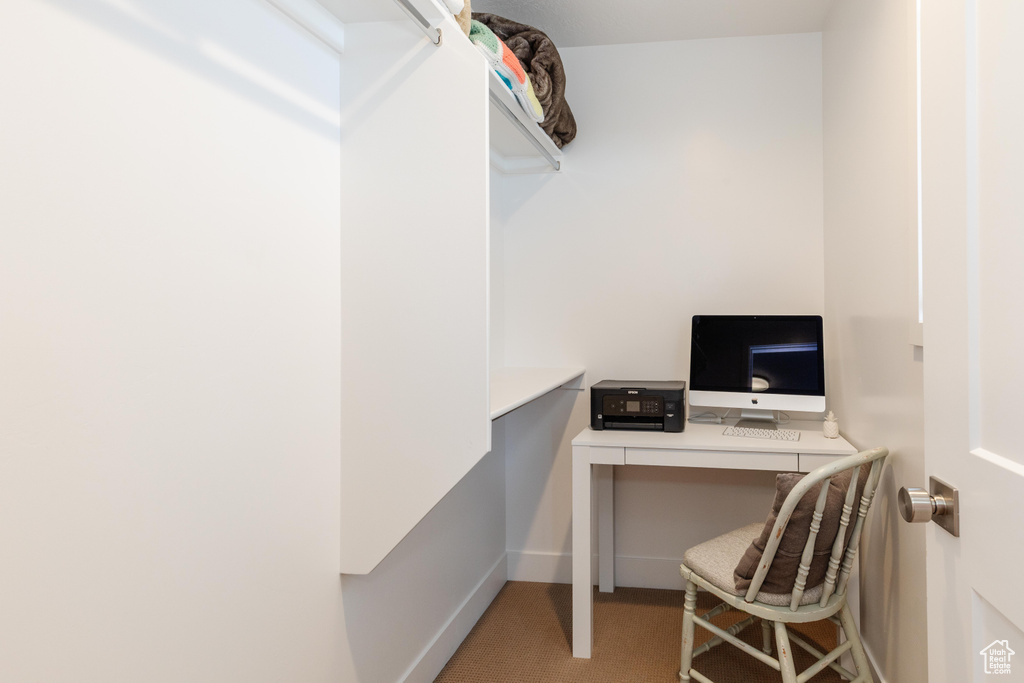 Office area featuring carpet floors and baseboards