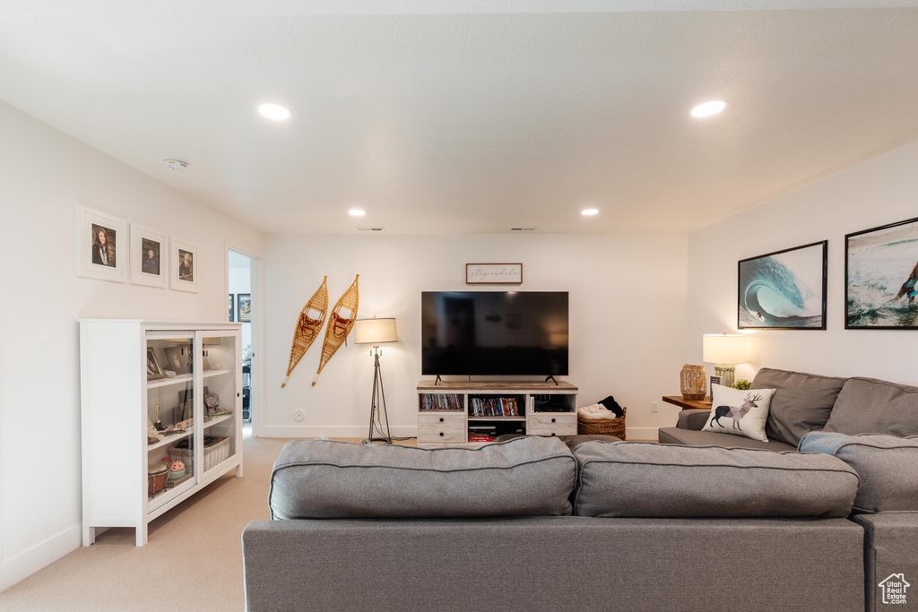 Living room featuring recessed lighting, light carpet, and baseboards