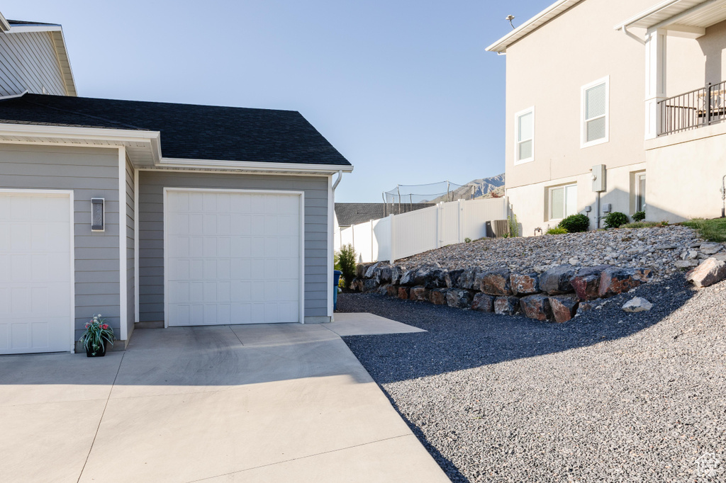 Garage featuring concrete driveway