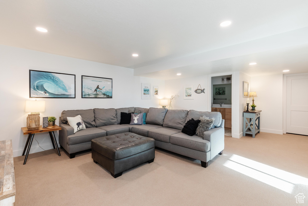 Living room with light colored carpet, recessed lighting, and baseboards