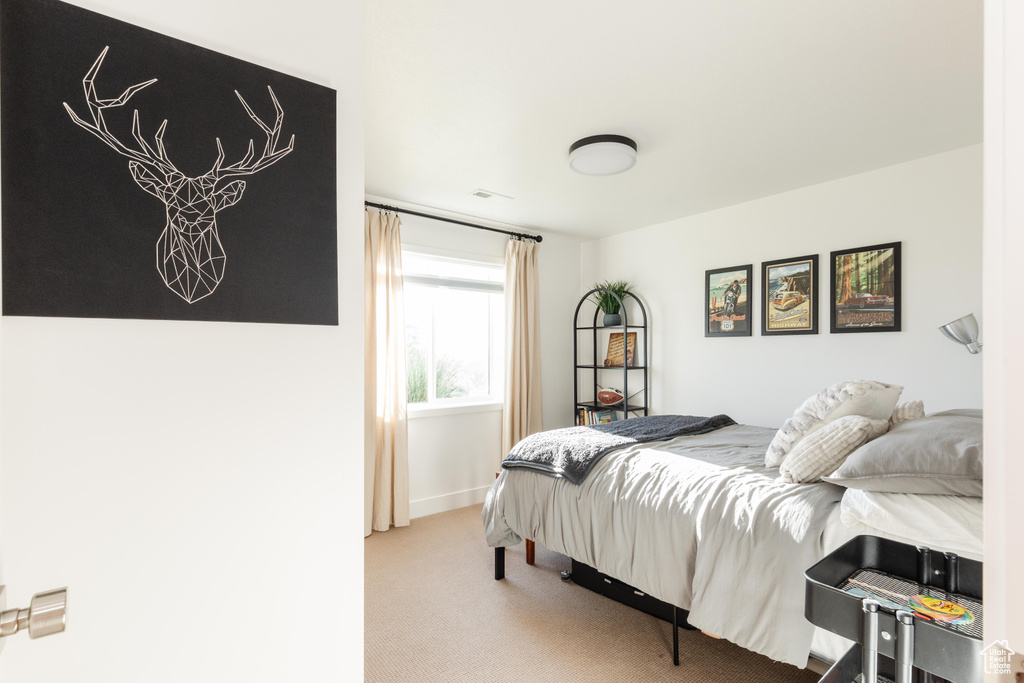 Carpeted bedroom featuring baseboards