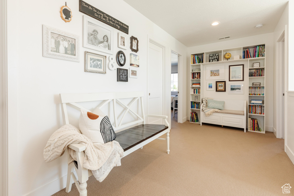 Sitting room featuring carpet floors, baseboards, and recessed lighting