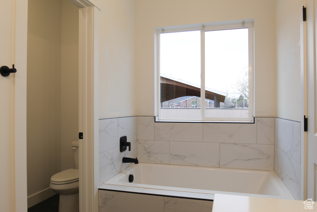 Bathroom featuring toilet and a bath
