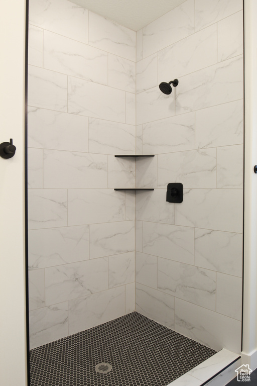 Full bath featuring tiled shower