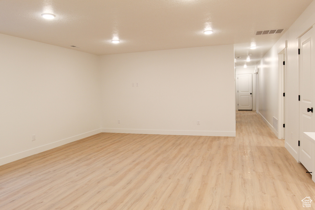 Unfurnished room with light wood-type flooring and baseboards