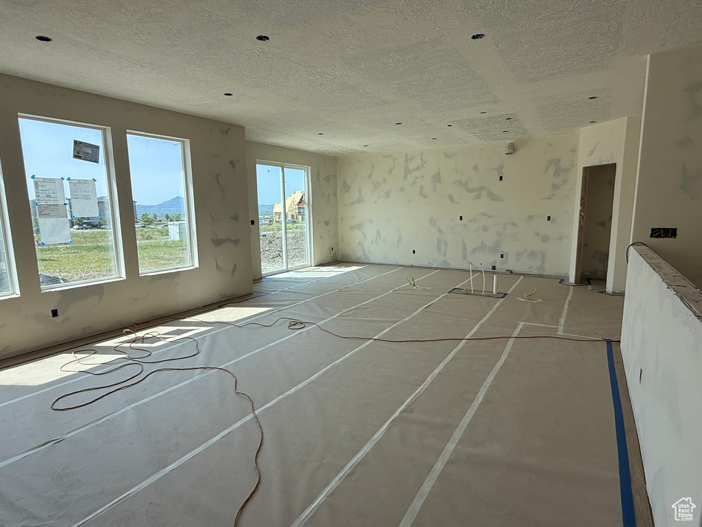 Unfurnished living room with a textured ceiling