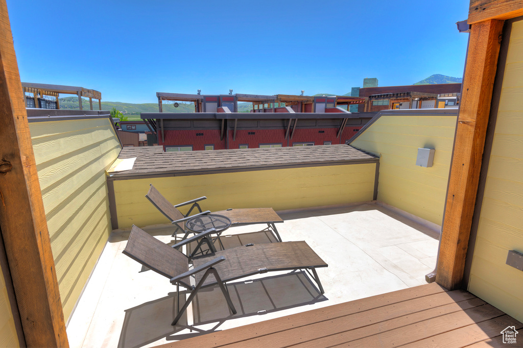 View of patio / terrace with a mountain view and a balcony