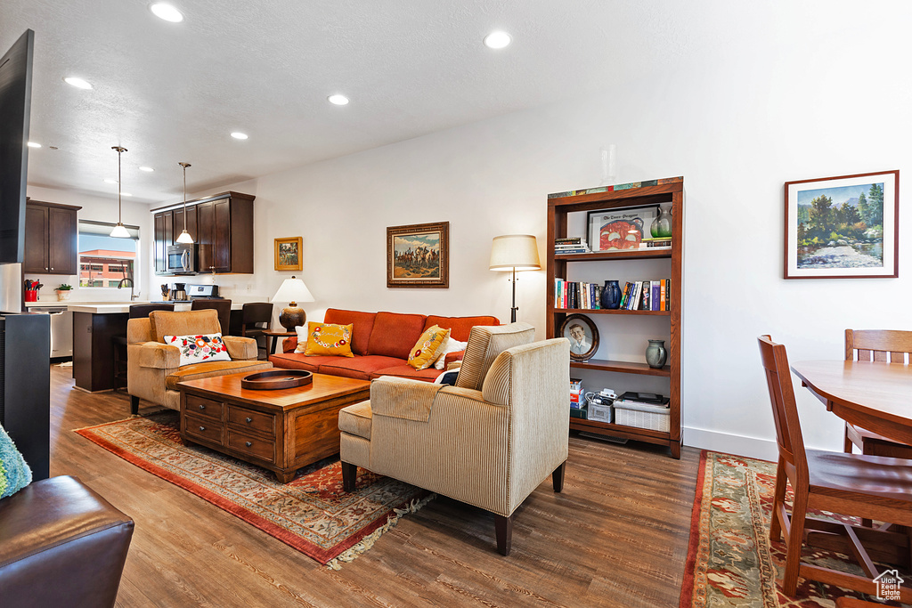 Living room featuring dark wood-style floors and recessed lighting