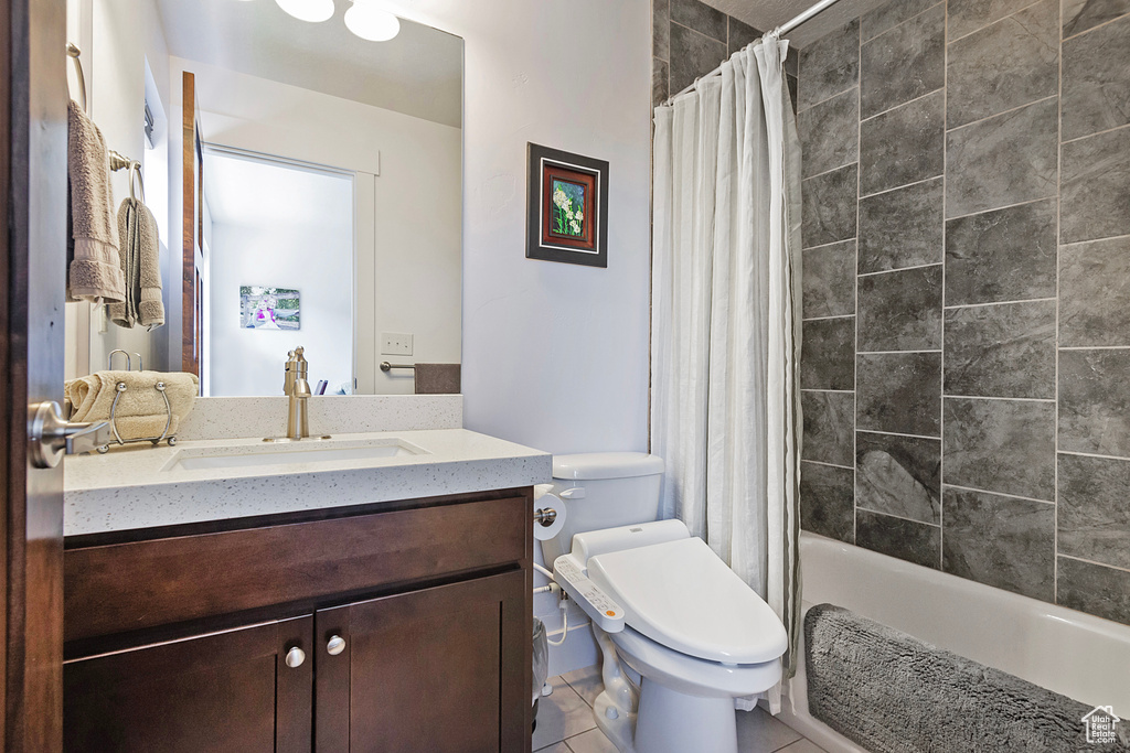 Full bath with vanity, toilet, shower / tub combo with curtain, and tile patterned flooring