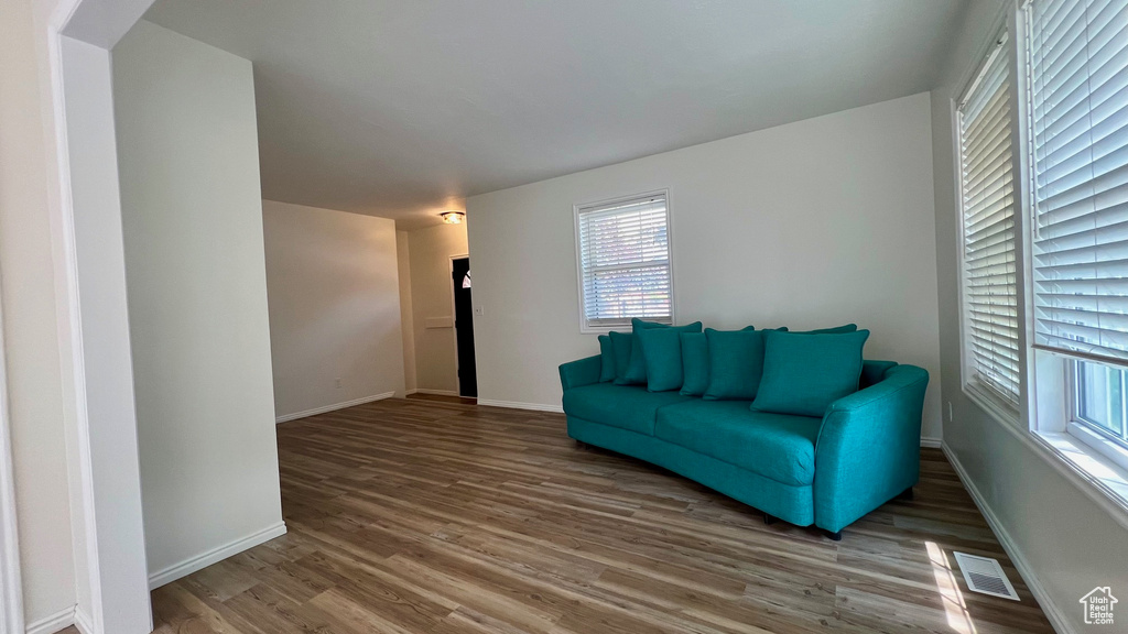 Living area with wood finished floors and baseboards