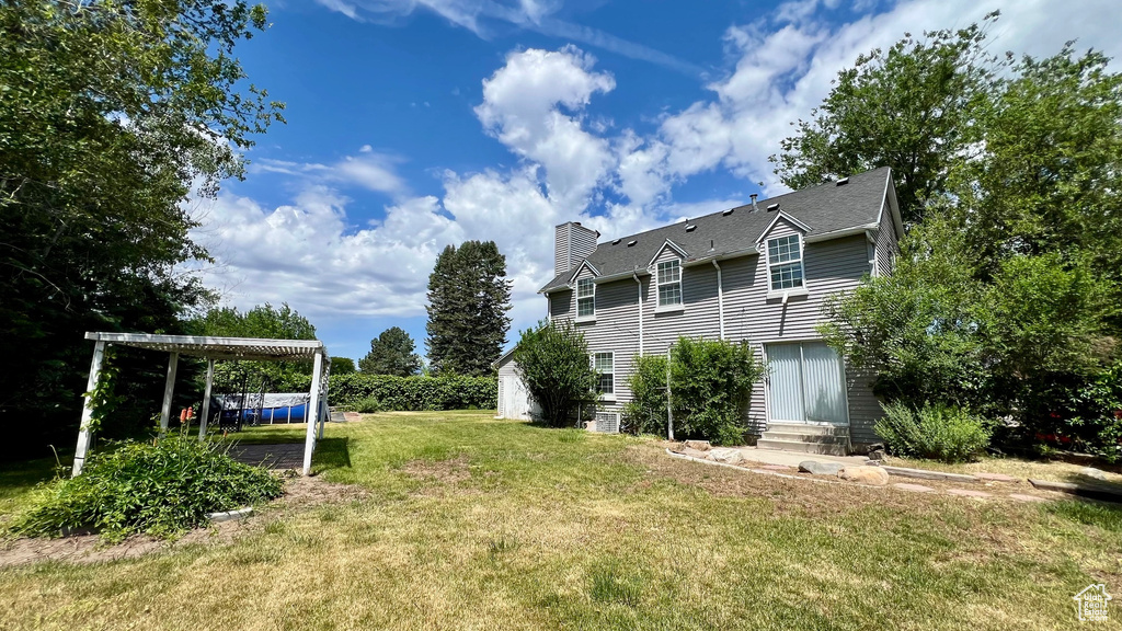 View of grassy yard featuring entry steps