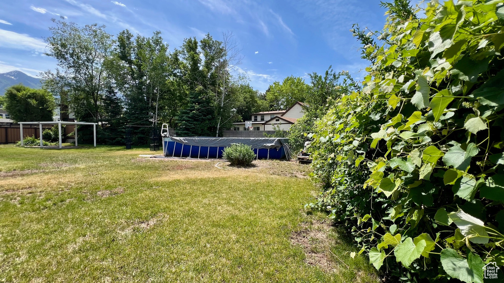 View of green lawn featuring an outdoor pool