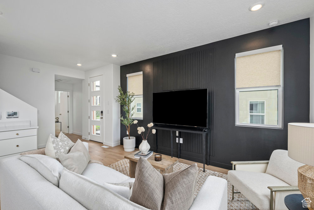 Living room featuring recessed lighting, light wood finished floors, and baseboards