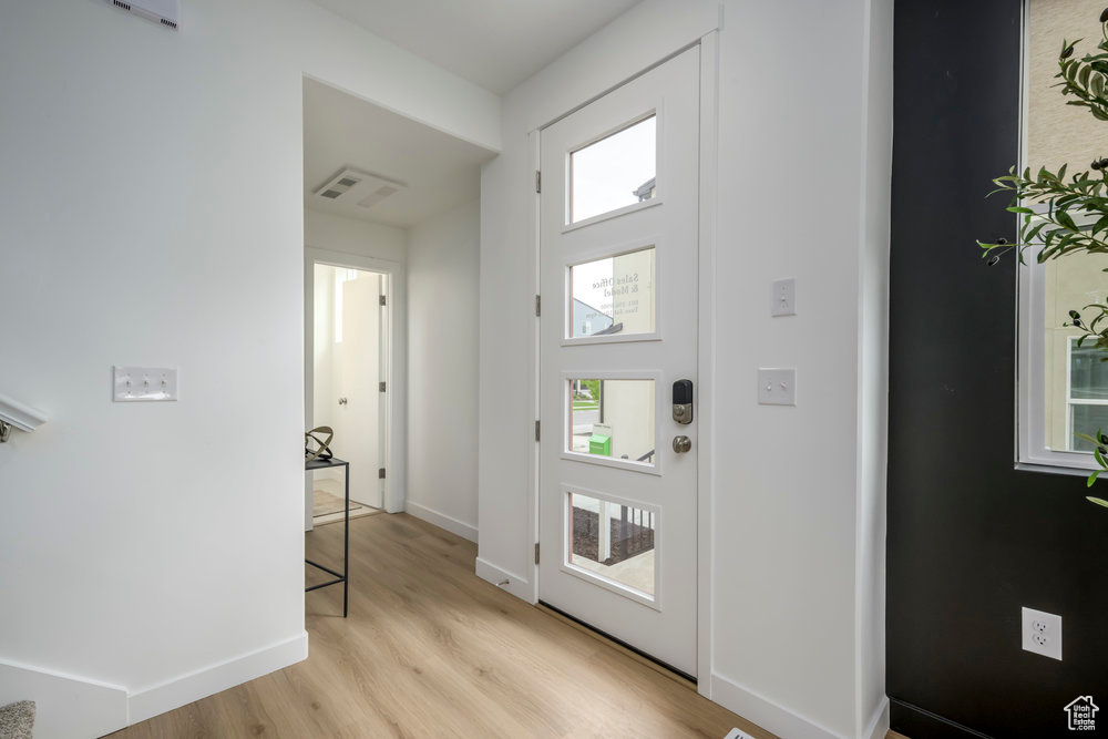 Entryway featuring light wood-style flooring and baseboards