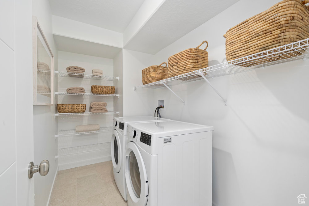 Laundry room with baseboards and washer and clothes dryer