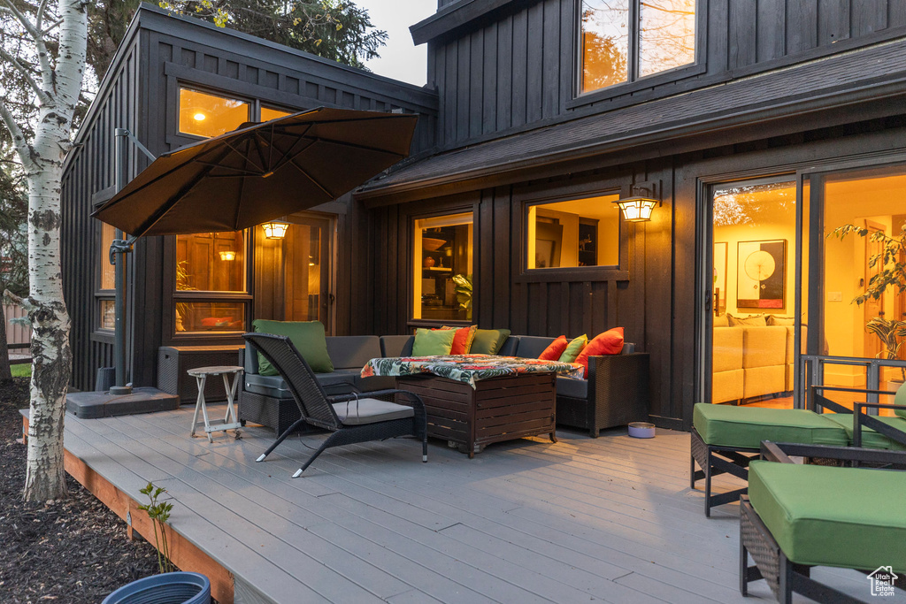 Wooden terrace with an outdoor living space with a fire pit