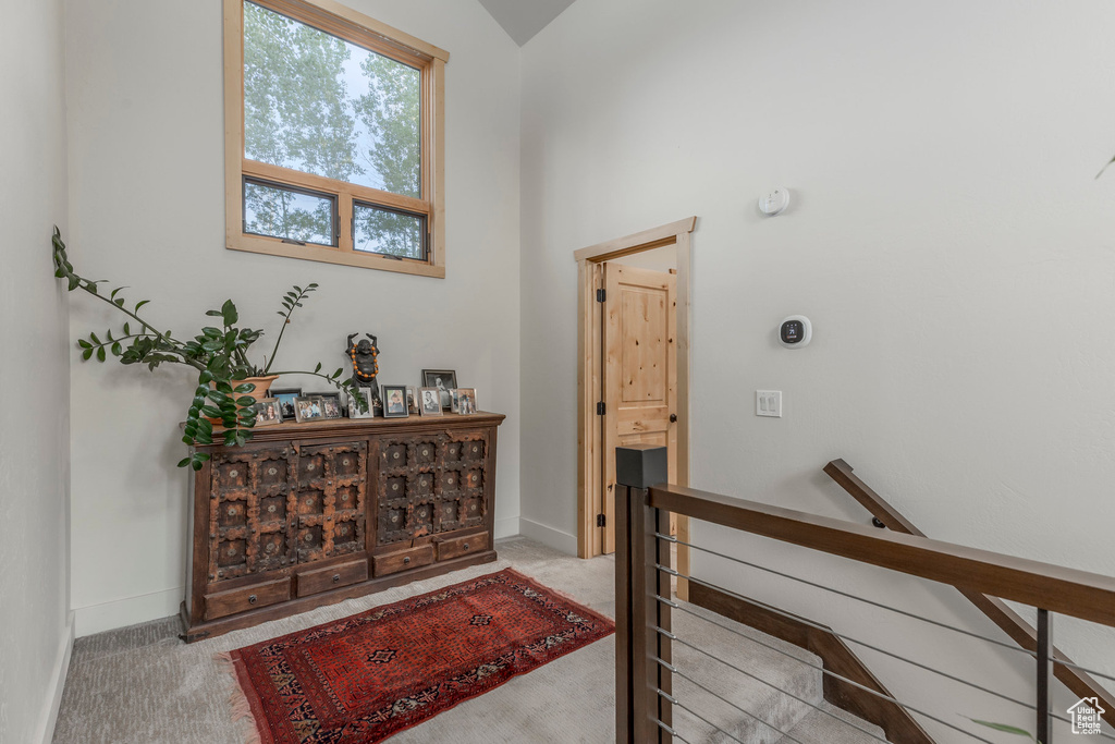 Carpeted foyer with baseboards