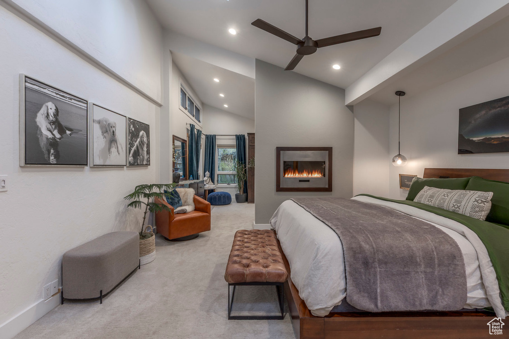 Carpeted bedroom featuring a lit fireplace, recessed lighting, baseboards, lofted ceiling, and a ceiling fan