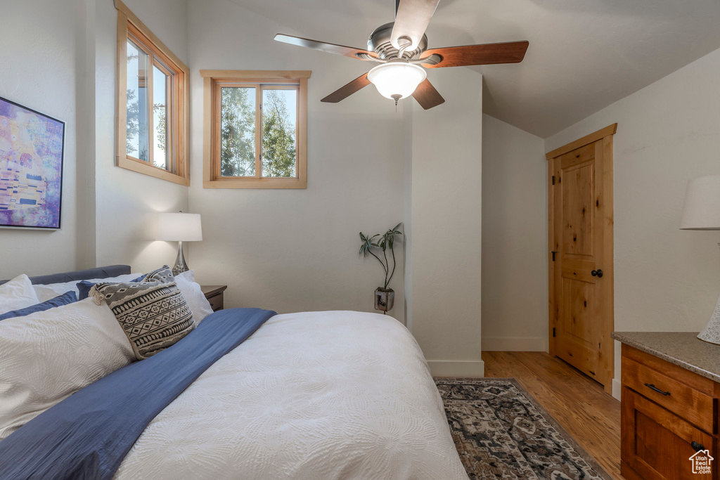 Bedroom with light wood-style floors and ceiling fan
