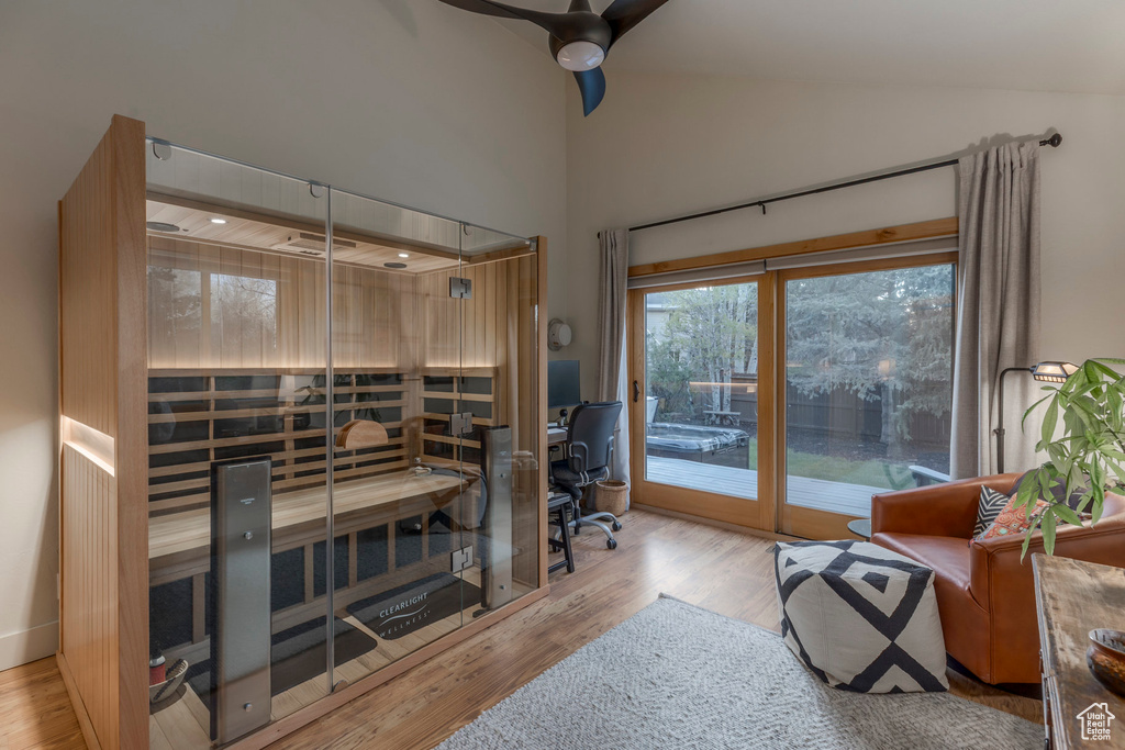 Office with a sauna / steam room, a ceiling fan, wood finished floors, and high vaulted ceiling