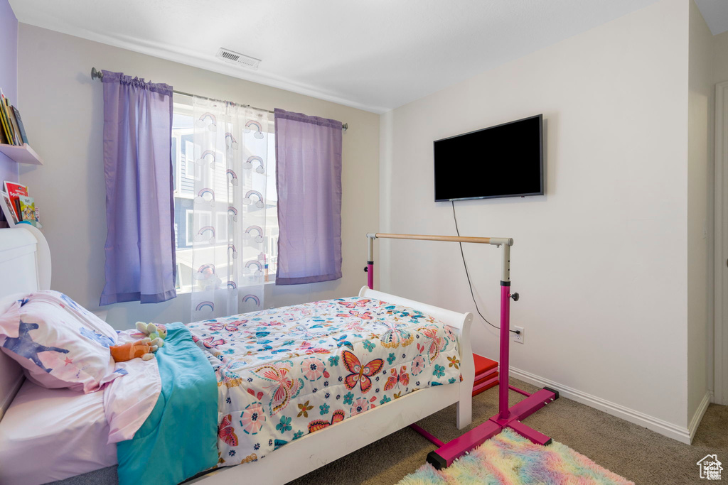 Carpeted bedroom featuring baseboards