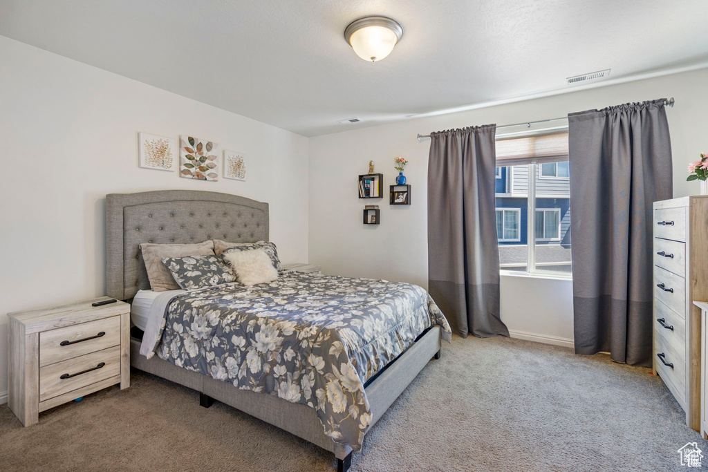 Carpeted bedroom featuring baseboards