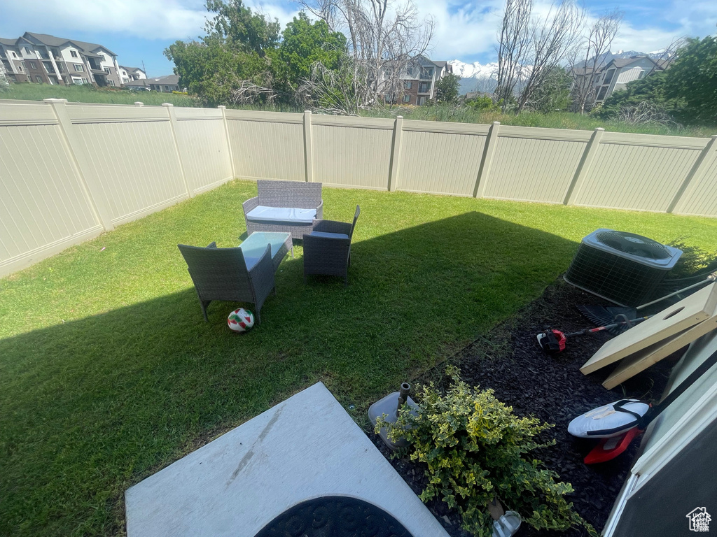 View of yard featuring central AC unit and a residential view