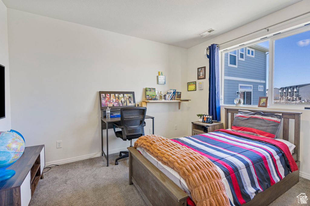 Carpeted bedroom featuring baseboards