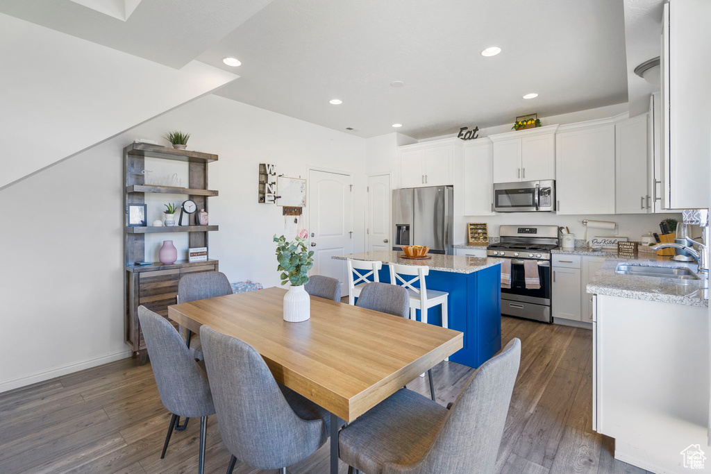 Dining area featuring recessed lighting and dark wood-type flooring