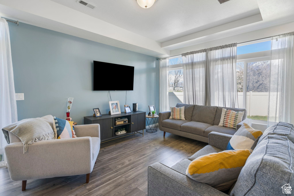Living area with wood finished floors and plenty of natural light