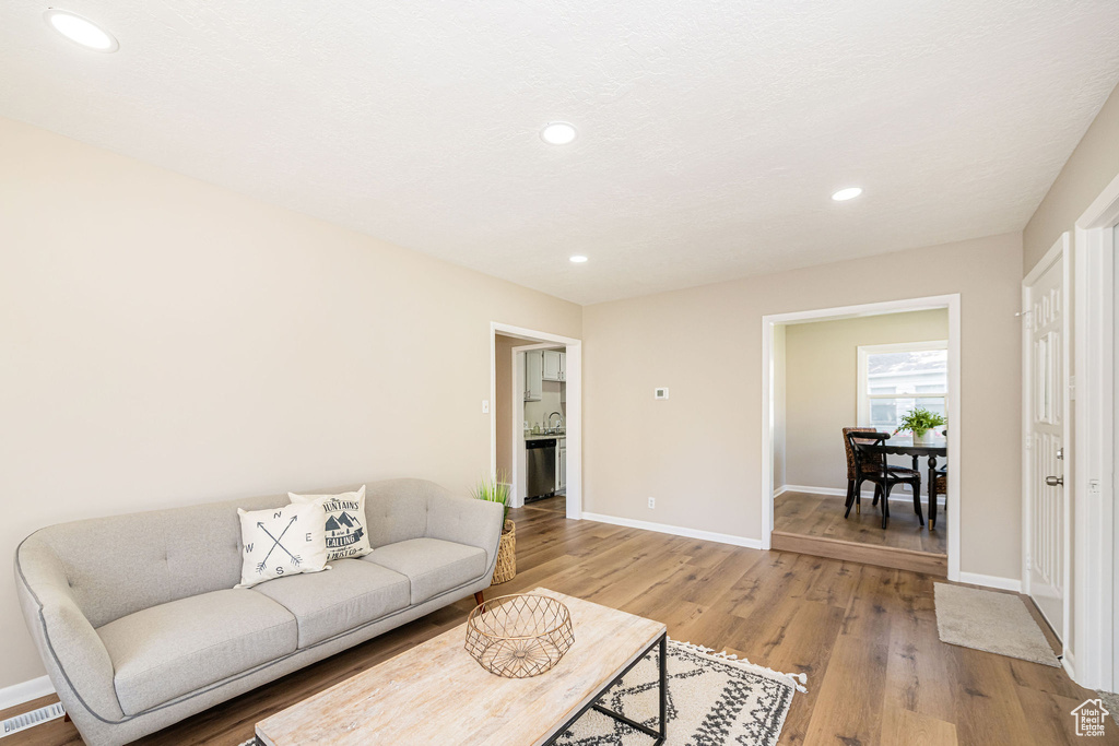 Living area featuring light wood-style flooring and recessed lighting