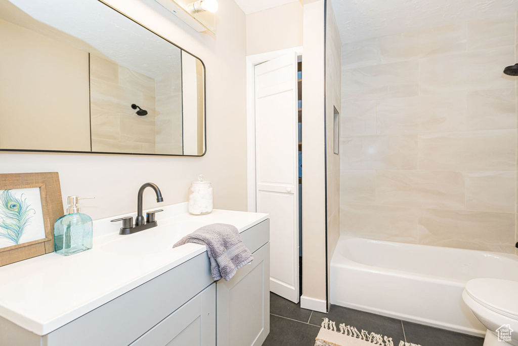 Full bath with tile patterned flooring, vanity, and tub / shower combination