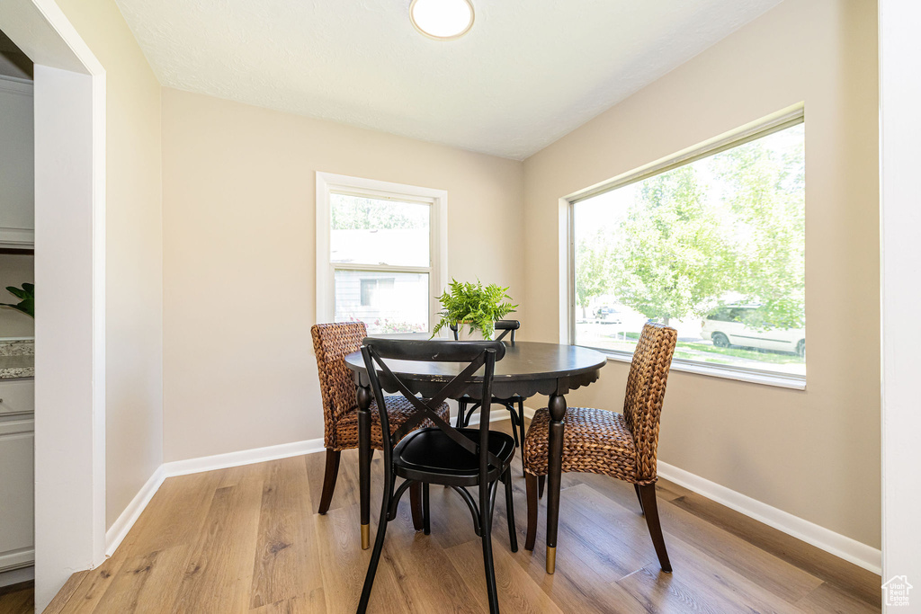 Dining area with light wood-style flooring and baseboards
