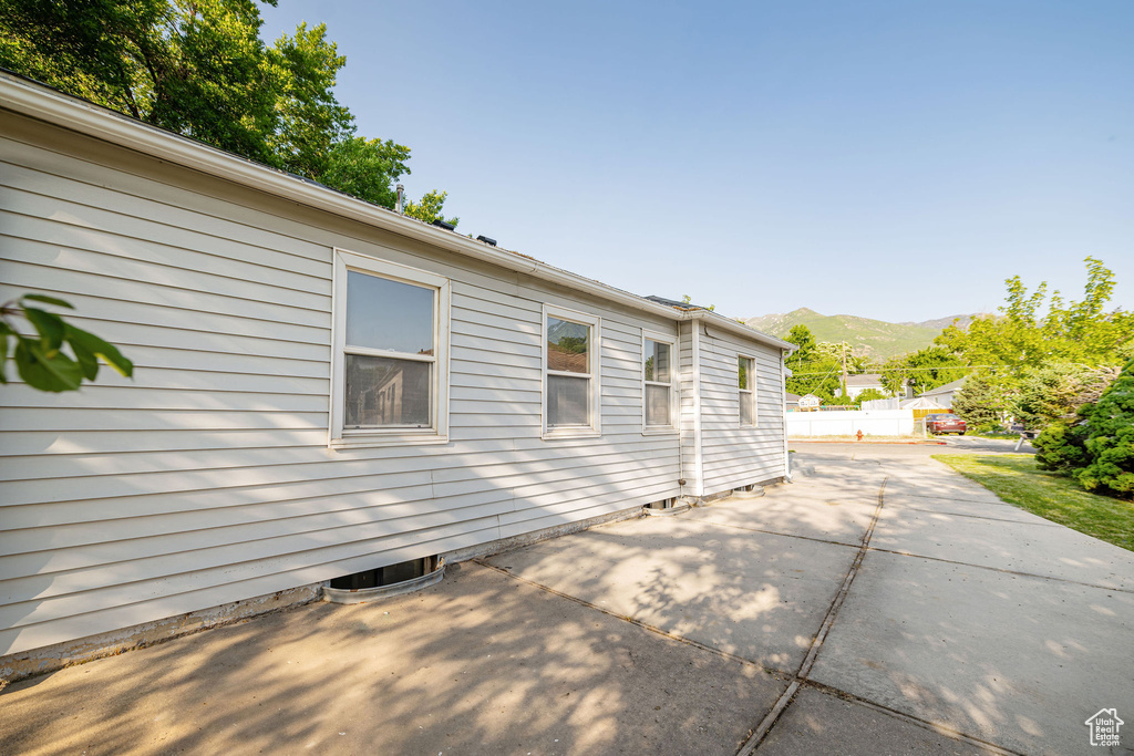 View of home\'s exterior with a patio area, a mountain view, and central AC